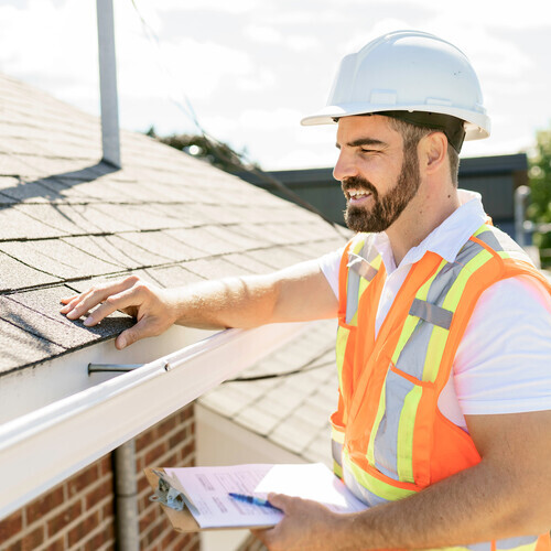 a worker providing a roof inspection