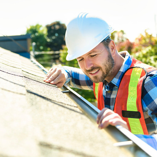 a man inspecting a roof