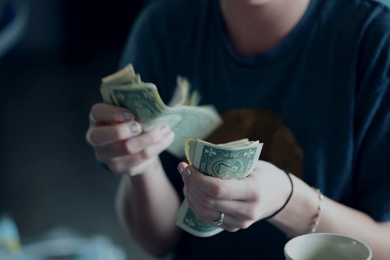 woman counting cash in her hands