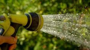 a water sprinkler to clean rain gutters and downspout